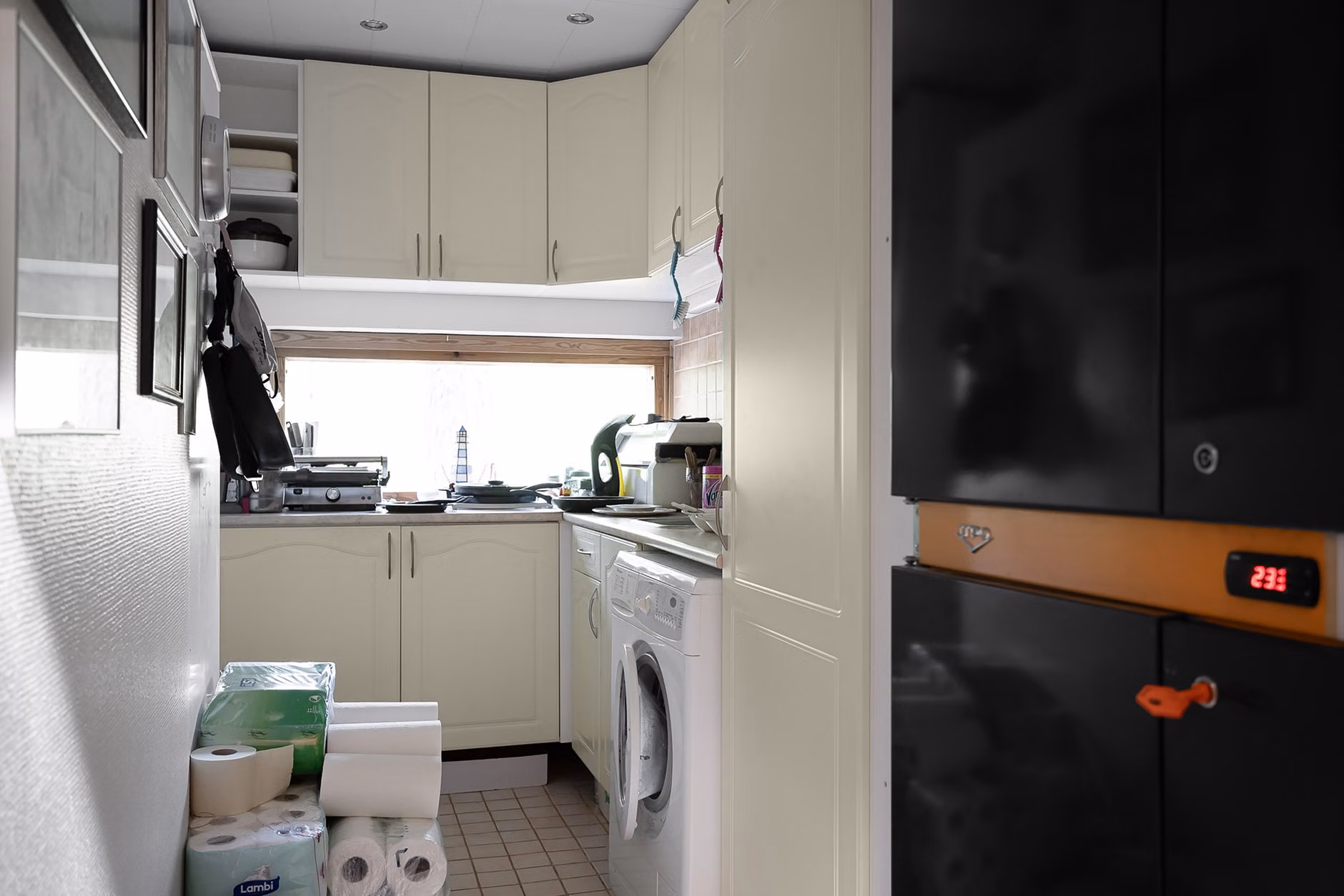 A modern energy-efficient laundry setup in a home utility room.