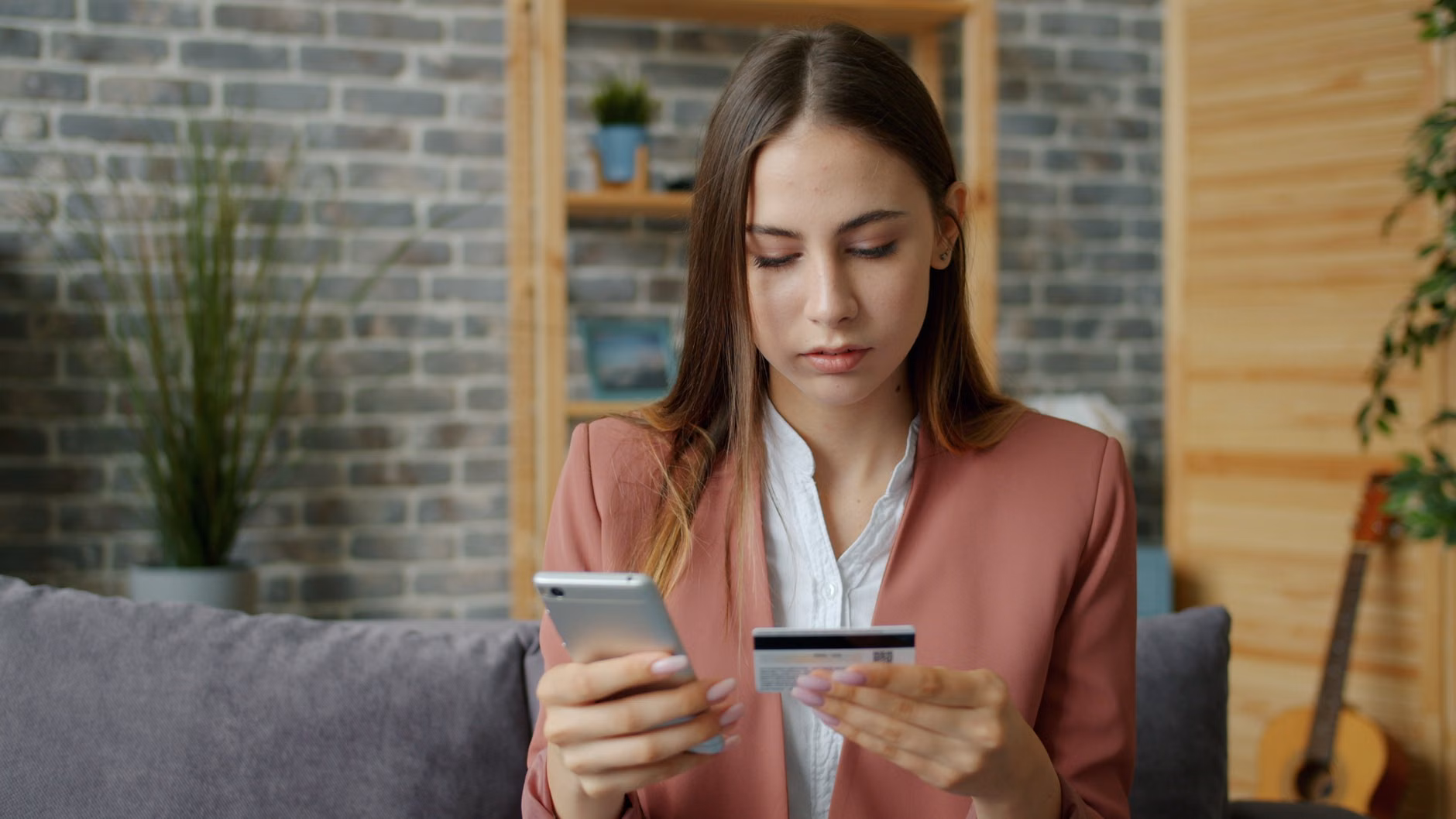 A professional using a mobile app to research and purchase second-hand luxury workwear.