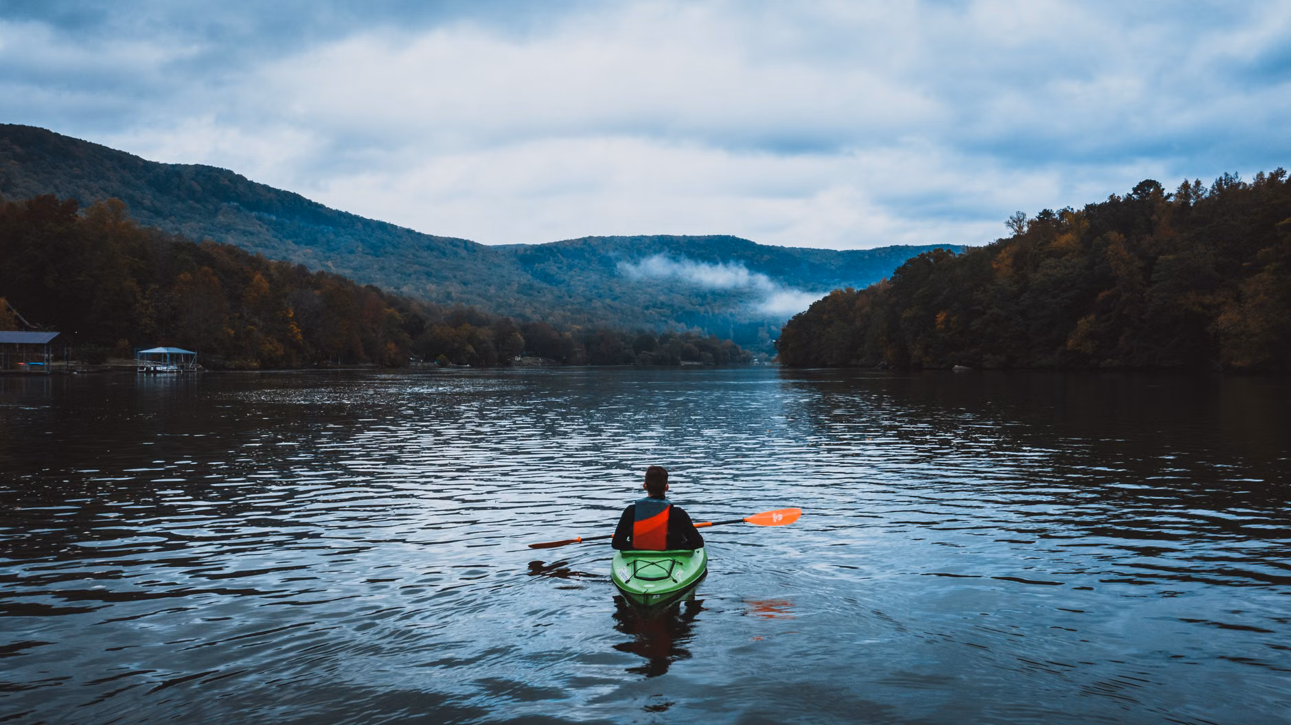 A person enjoying a peaceful kayak trip on a quiet river.