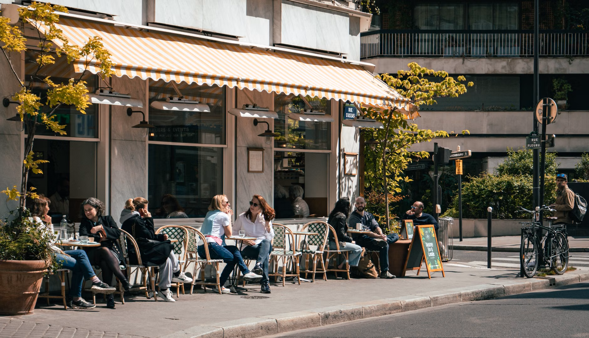 A family relaxing at a harbor-side cafe on a pedestrian-friendly island.