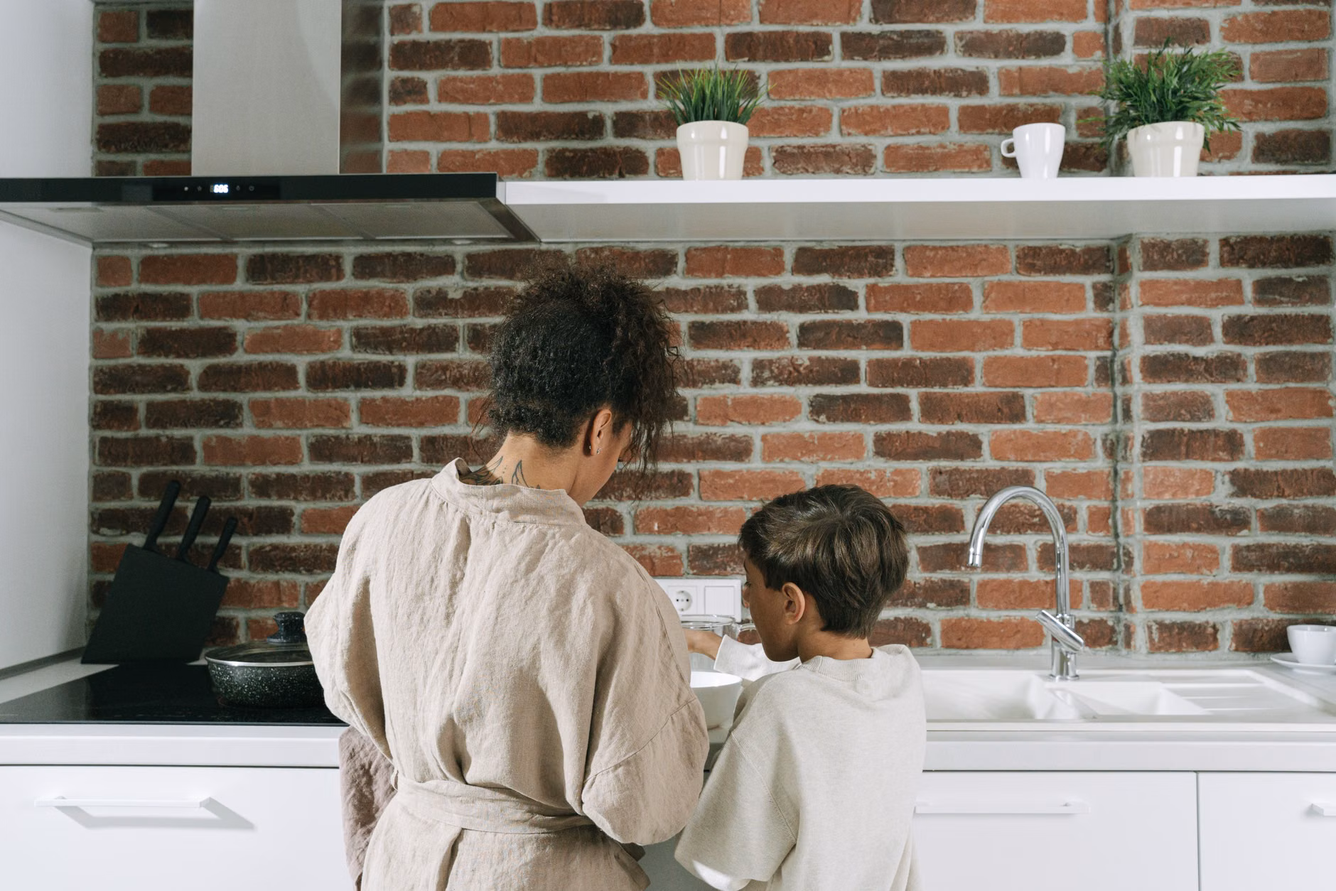 Parent and child reviewing a wall-mounted visual morning schedule.
