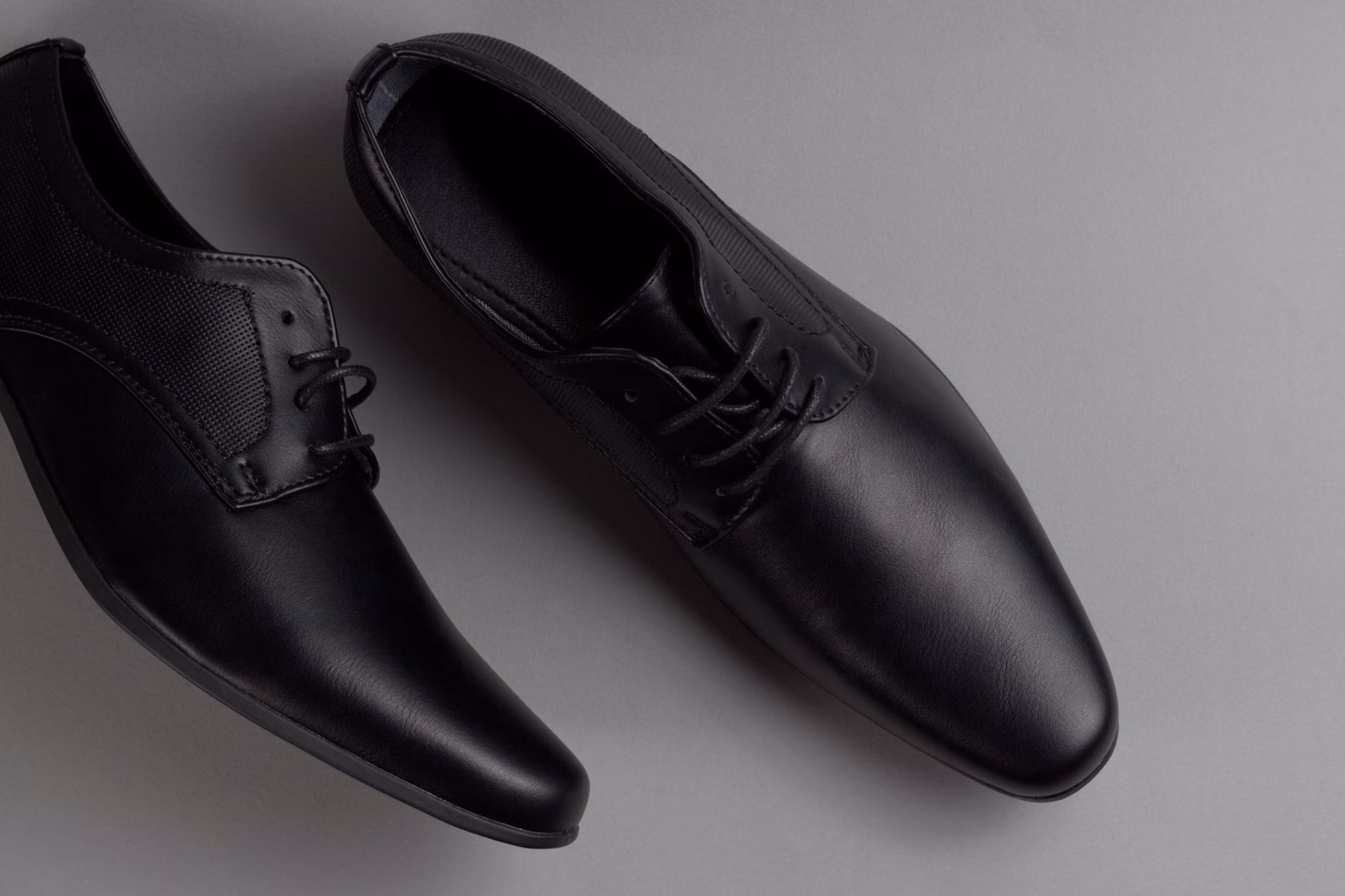 Classic leather work shoes in a well-lit, minimalist setting.