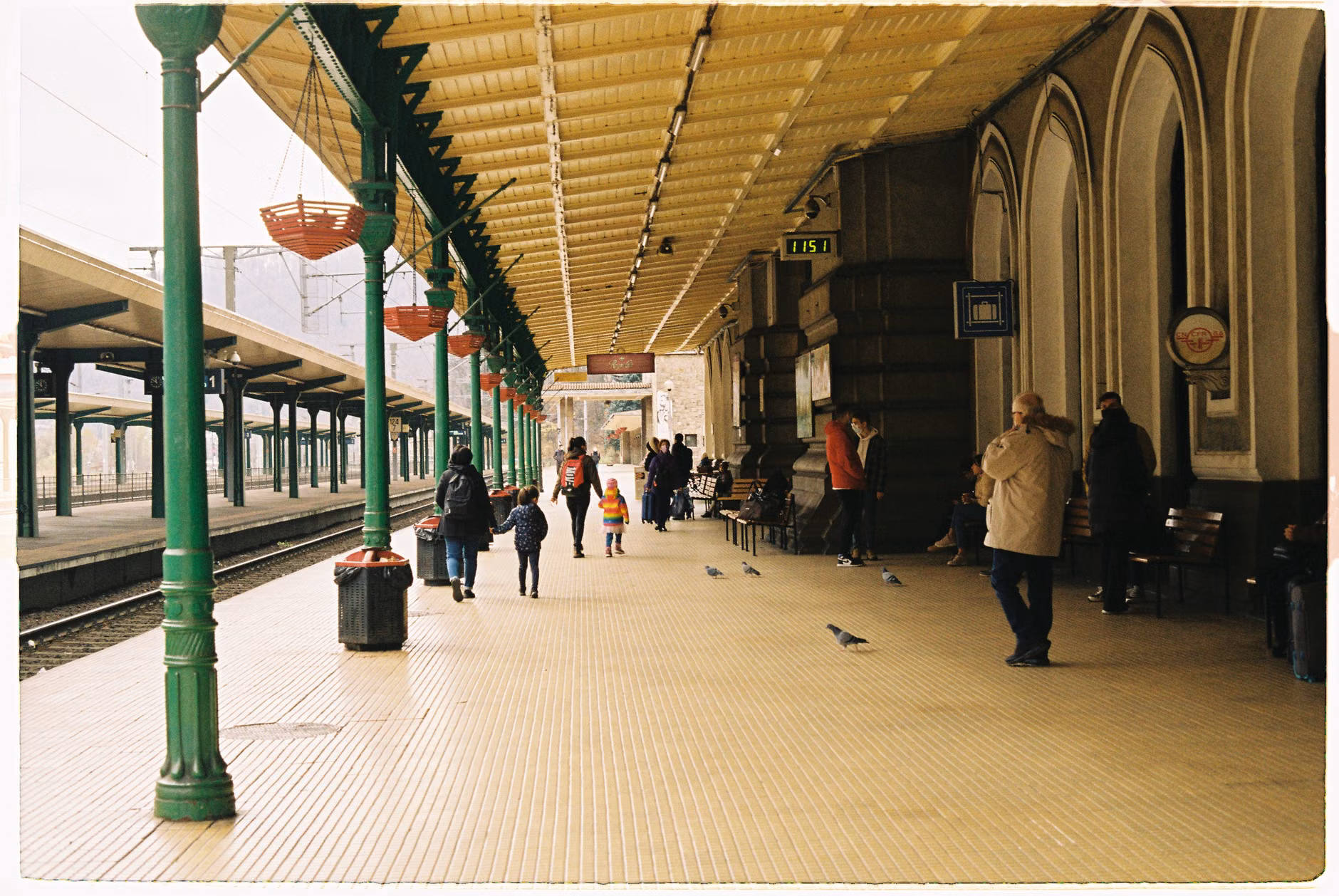 Family walking near a historic coastal train station