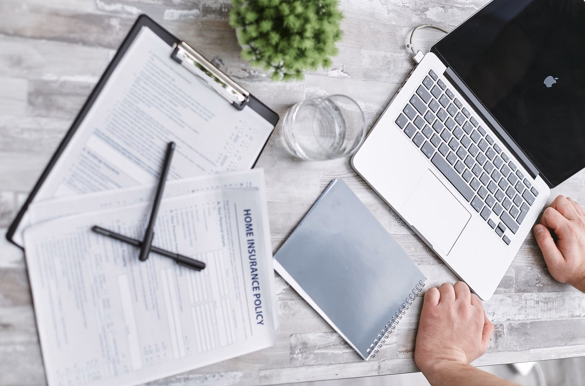 An expat reviewing medical insurance documents on a laptop.