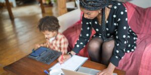 A family working and learning remotely in a scenic international location.