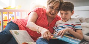 An older adult and child sharing family stories on a tablet.