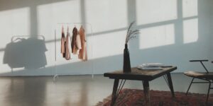 Modern minimalist clothing rack in a sunlit room