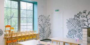 A modern, calm, and acoustically treated primary school cafeteria interior.