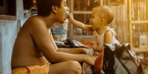 A parent and toddler sitting together in a calm, sunlit room, focusing on emotional connection.