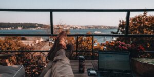 A professional relaxing on a balcony, representing a break from the daily grind.
