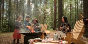 A family enjoying a sustainable camping trip in a forest setting.