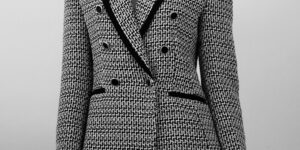 A curated professional closet featuring high-quality blazers and tailored clothing.