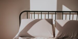 A peaceful, sunlit bedroom scene representing a calm morning routine.