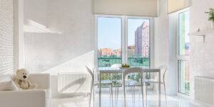 A minimalist, sunlit urban apartment living room focusing on intentional space.