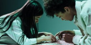 A focused pre-teen working on a challenging puzzle at a desk.