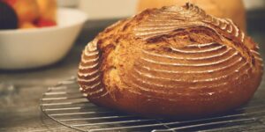 Artisanal sourdough bread cooling on a home kitchen counter.