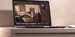 A modern home office setup featuring a laptop displaying a health dashboard.