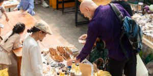 A family engaging in urban foraging during a weekend outing in a green city park.