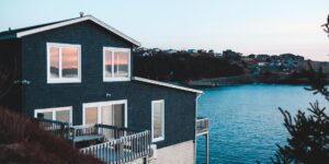 A modern sustainable coastal home during sunset.