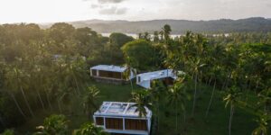 Modern eco-friendly coastal villa overlooking a sustainable shoreline.