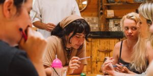 Friends planning a group vacation around a table.