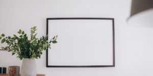 A clean, modern emotion chart hanging on a living room wall for toddler use.