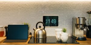 A tablet mounted on a wall displaying a smart home energy dashboard in a modern living room.