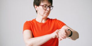 A parent checking their health data on a wearable device in a home setting.