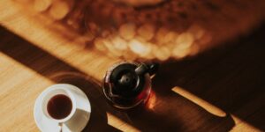 A peaceful, sunlit morning scene on a wooden table representing the slow-living philosophy.