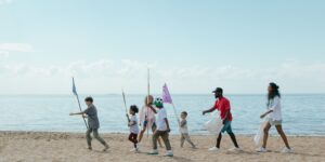 A family walking along a clean, sustainable coastline during a morning vacation.