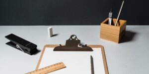 A organized, minimalist home planning setup on a wooden table.