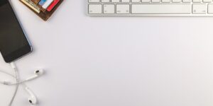 A smartphone and credit card on a desk representing digital subscription management.