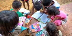Parents and children collaborating in a shared community learning environment.