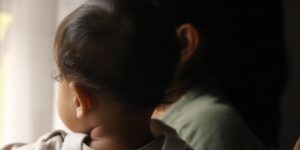 A parent enjoying a quiet moment of reflection at home.