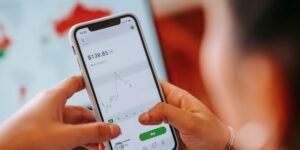 A modern smartphone screen showing a financial app for kids, symbolizing the shift to digital money management.
