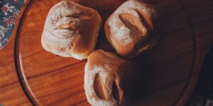 Artisan sourdough loaves and a tablet on a wooden table representing a micro-bakery business.