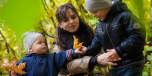 A parent and children exploring nature in an urban park for an educational foraging trip.