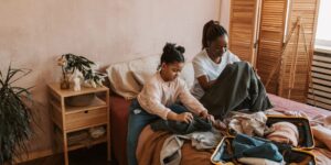 A parent and child planning a trip together in a cafe